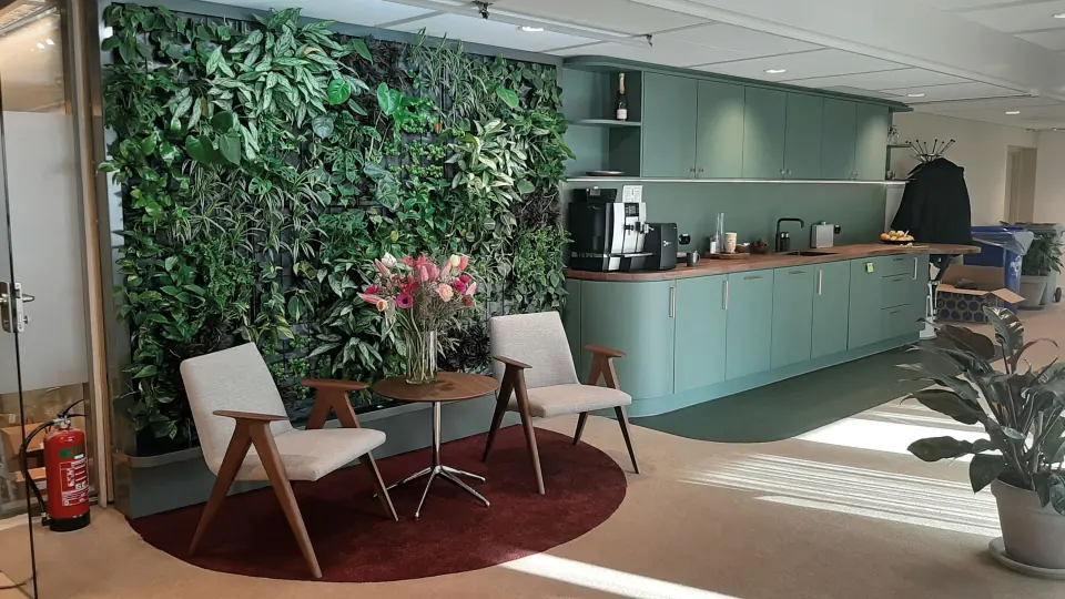 Zithoek voor een groene plantenwand in het kantoor van Schroders Real Estate